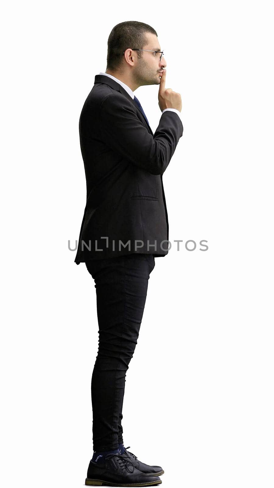 man in full growth. isolated on white background showing with finger to keep quiet