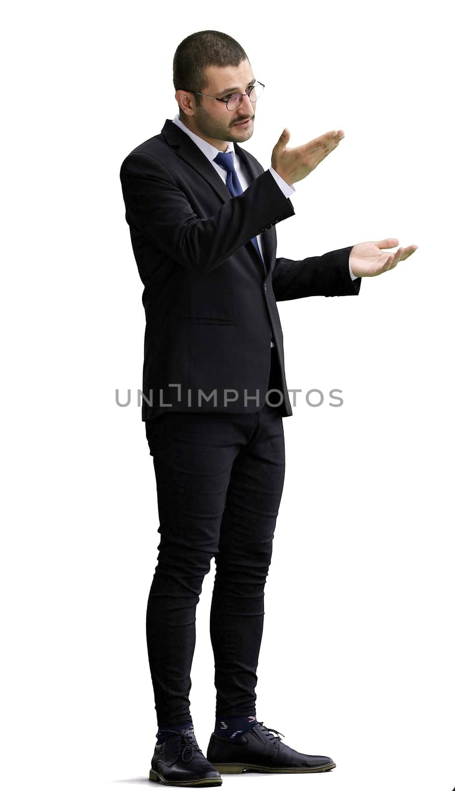 young man in full growth. isolated on white background demonstrates with hands.