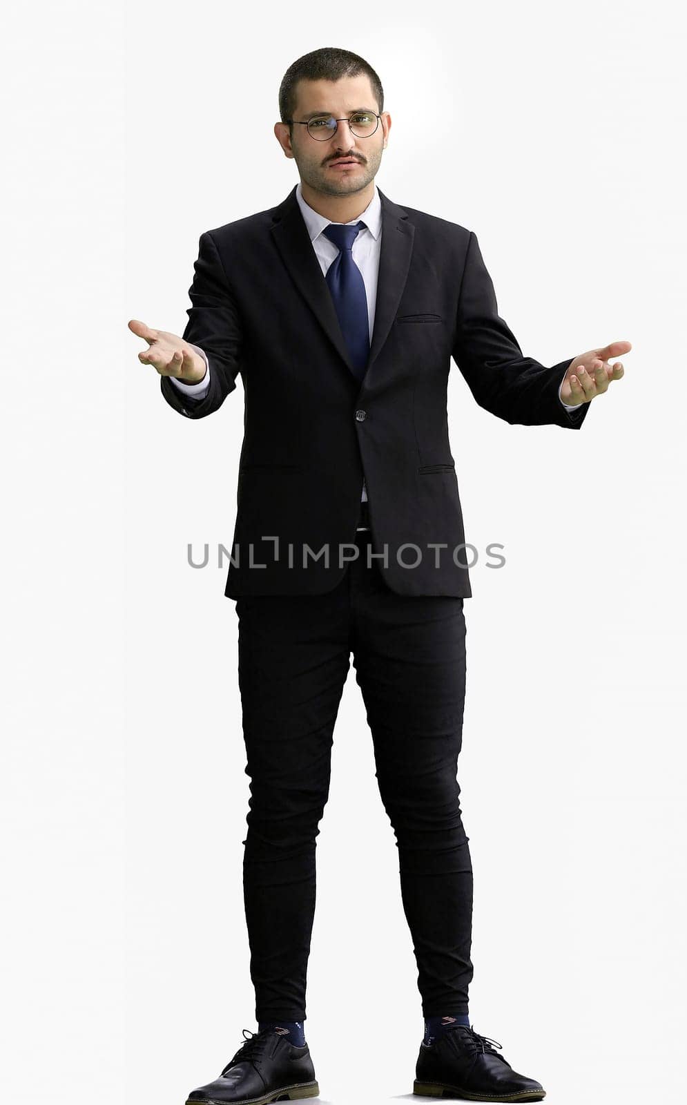 man in full growth. isolated on a white background shows with his hands a sign of what to expect.