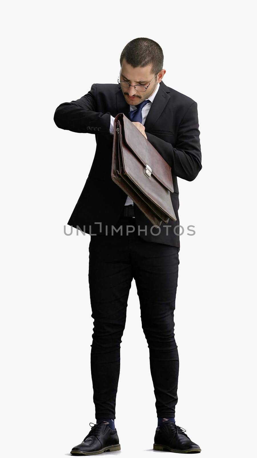 full-length portrait of a young man. standing isolated on white background.