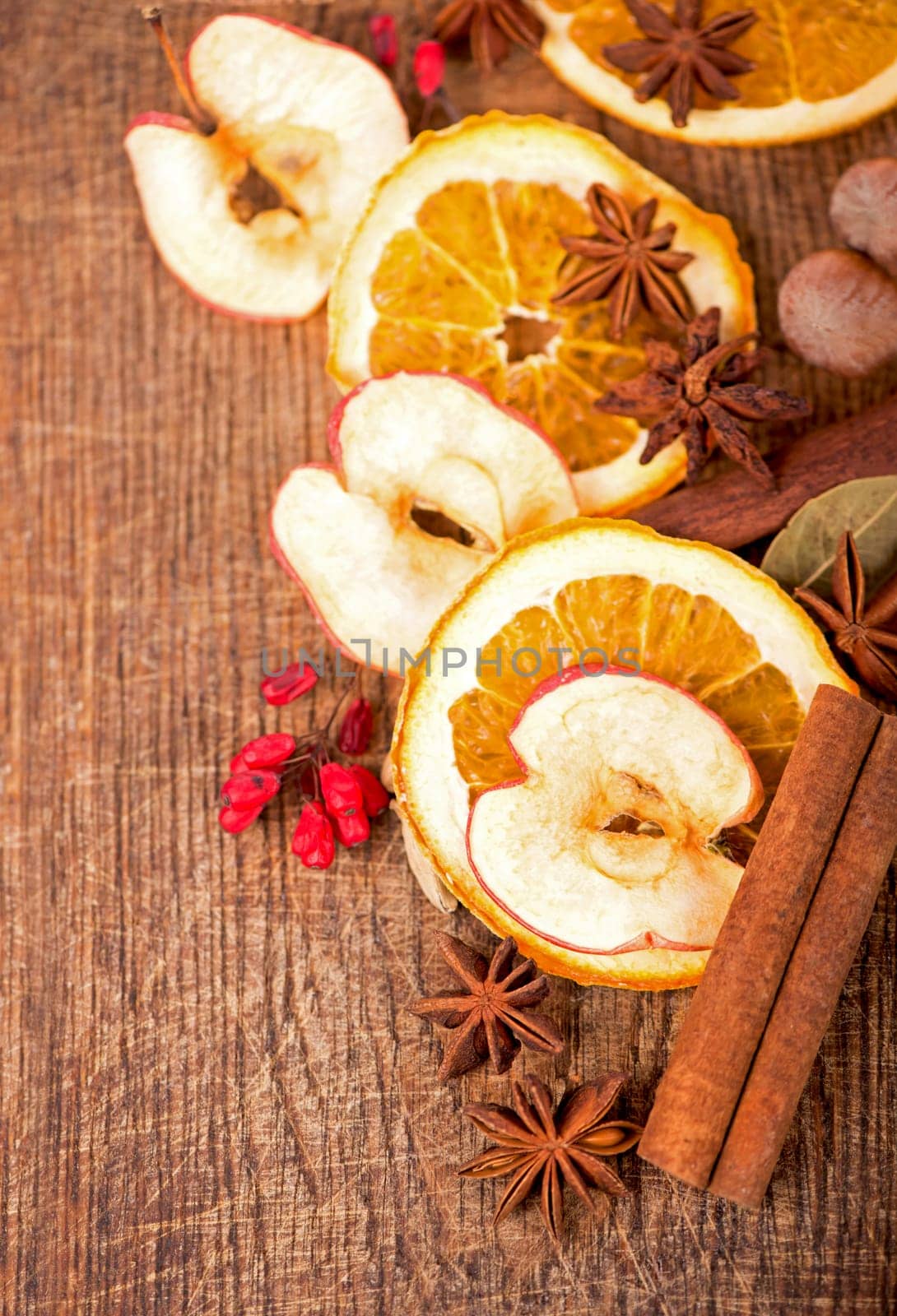 Christmas frame. Spices and dried orange sliceson on a wooden table