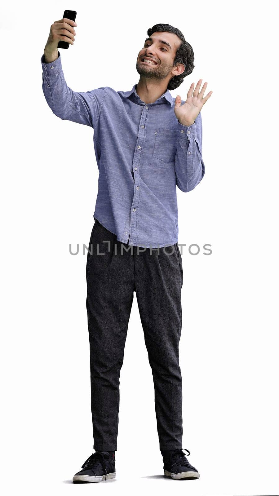 young man in full growth. isolated on white background taking selfie.