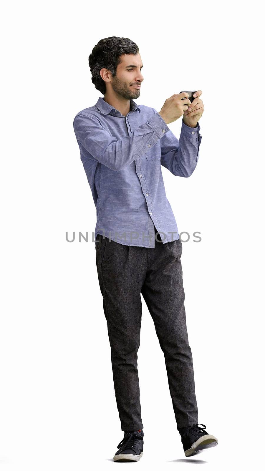 young man in full growth. isolated on white background taking selfie.