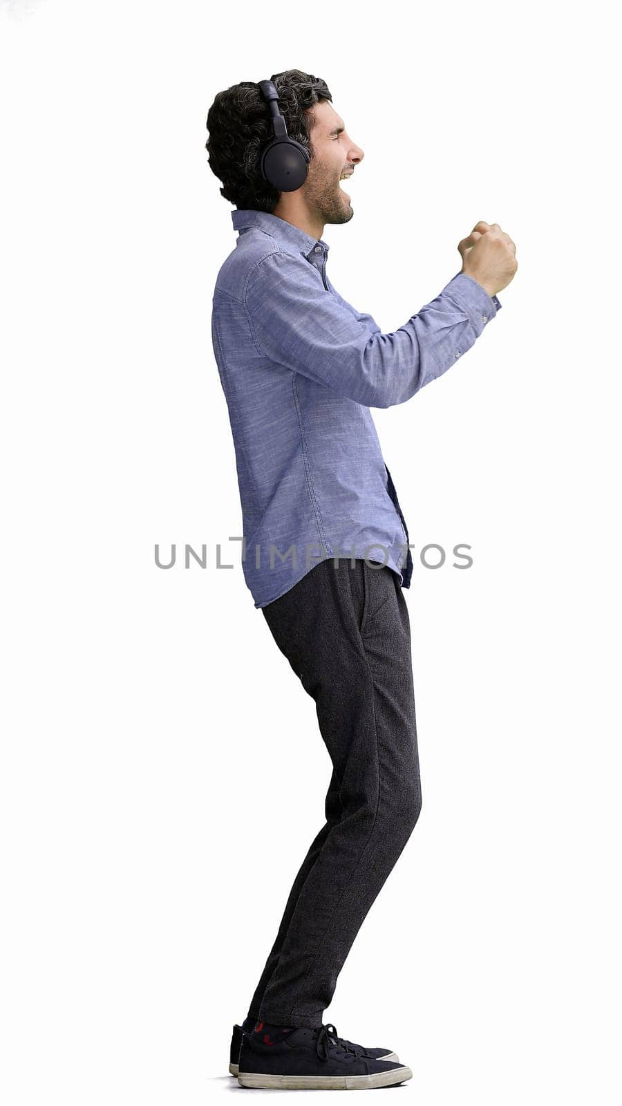 man in full growth. isolated on white background wearing headphones dancing.