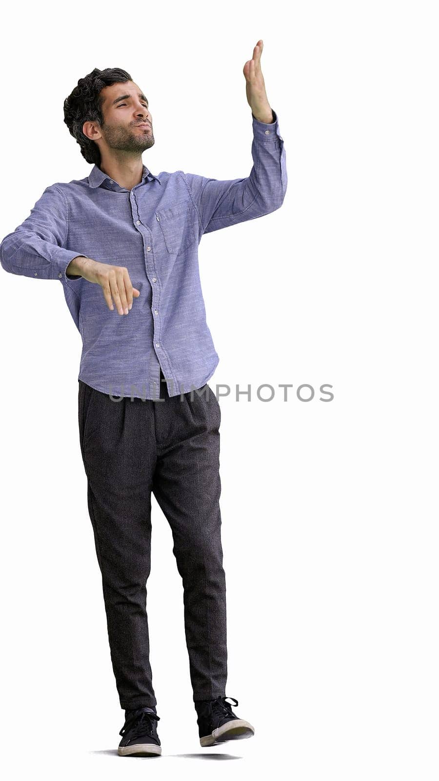 man in full growth. isolated on white background wearing headphones dancing.