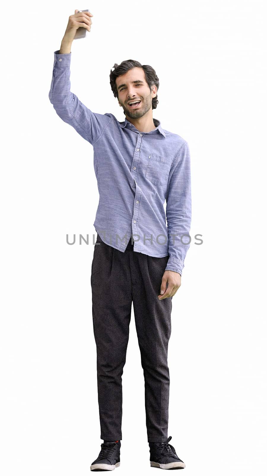 young man in full growth. isolated on white background rejoices.