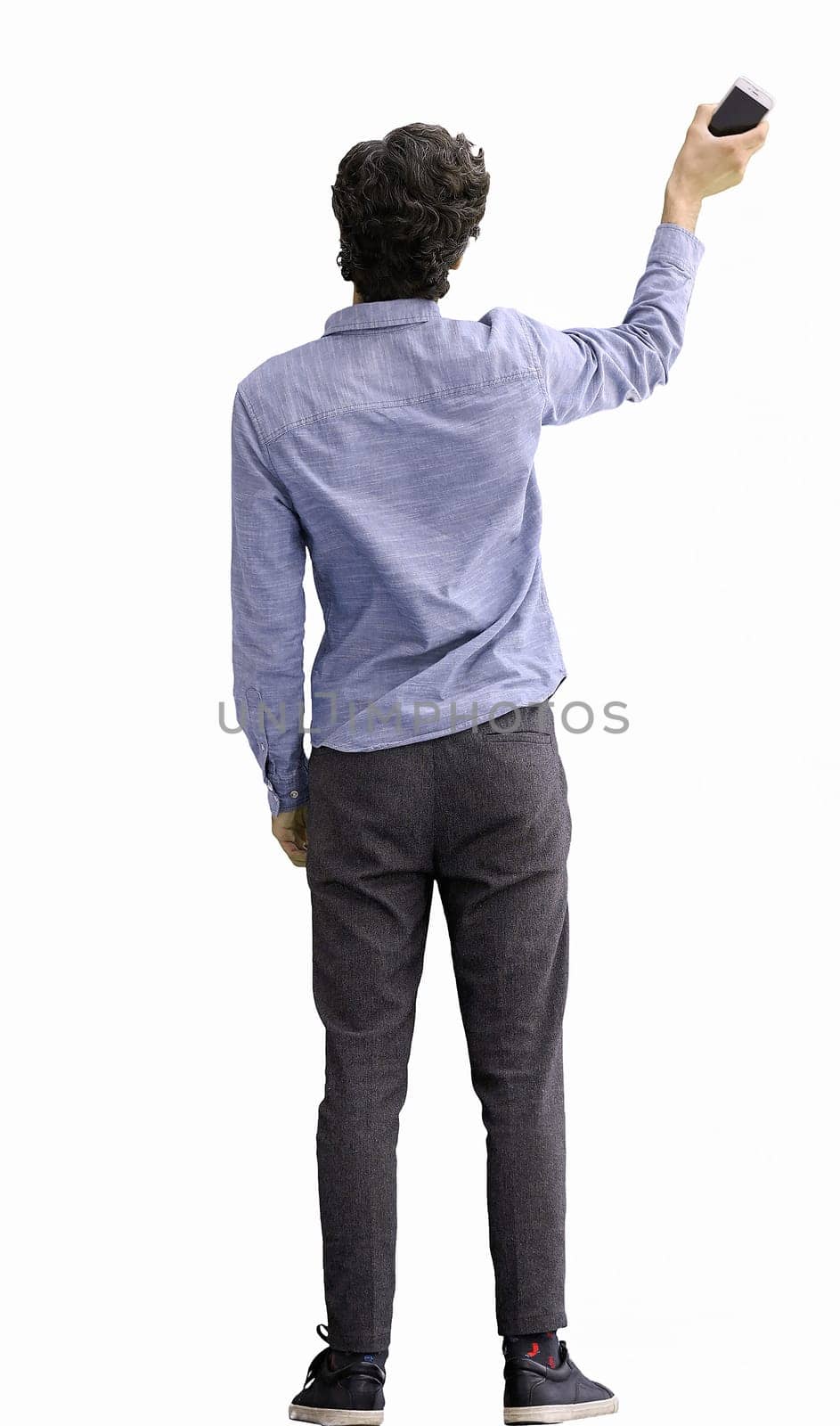 young man in full growth. isolated on white background rejoices.