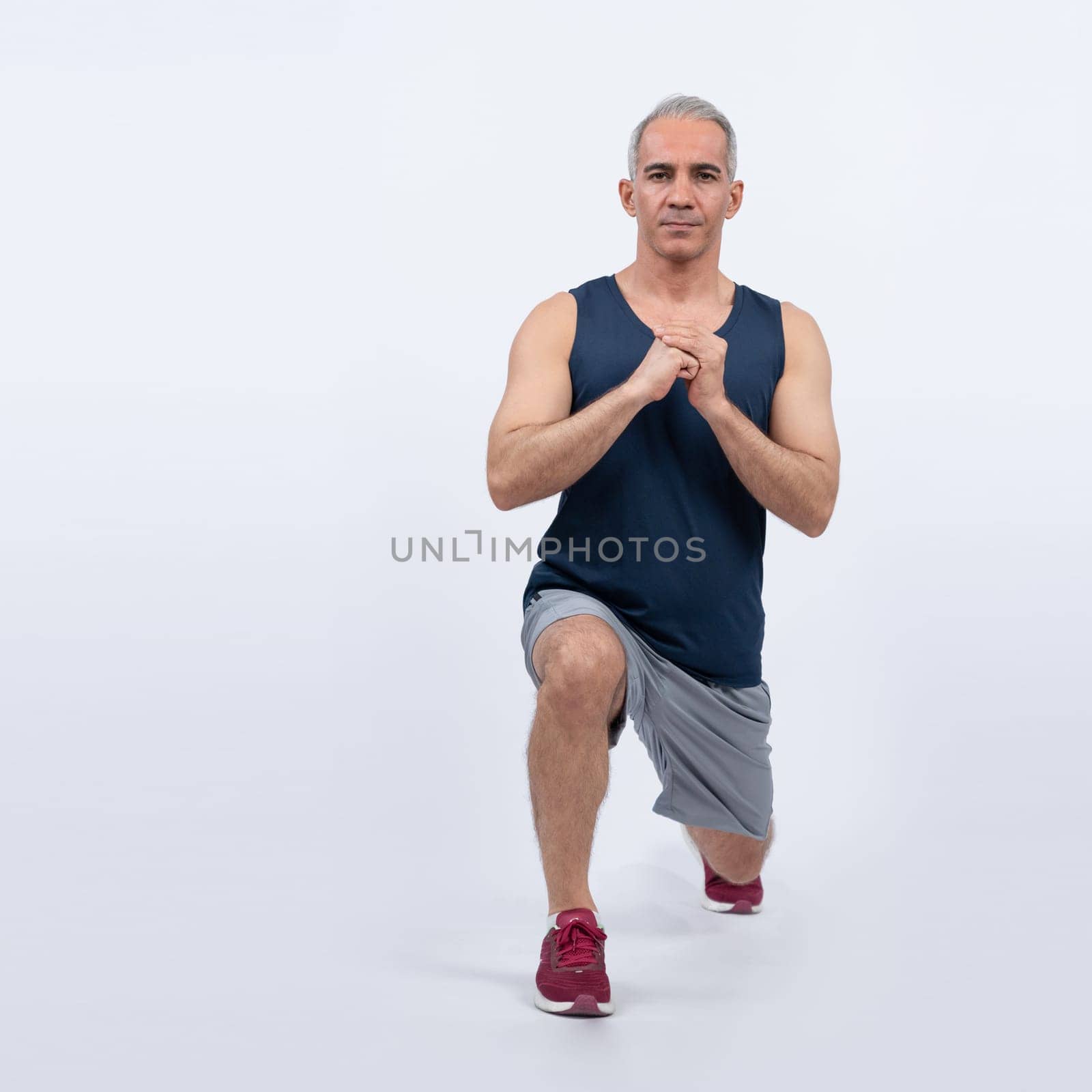 Active and fit physique senior man warming up before exercise on isolated background. Healthy lifelong senior people with fitness healthy and sporty body care lifestyle concept. Clout