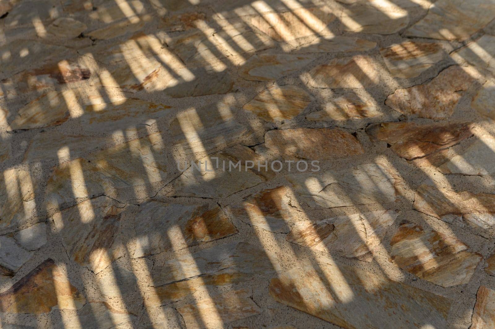 the sun shines through the thatched roof onto the stone floor, shadow and light