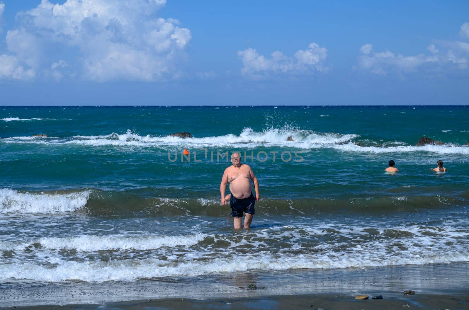 man on the Mediterranean beach on a sunny day by Mixa74