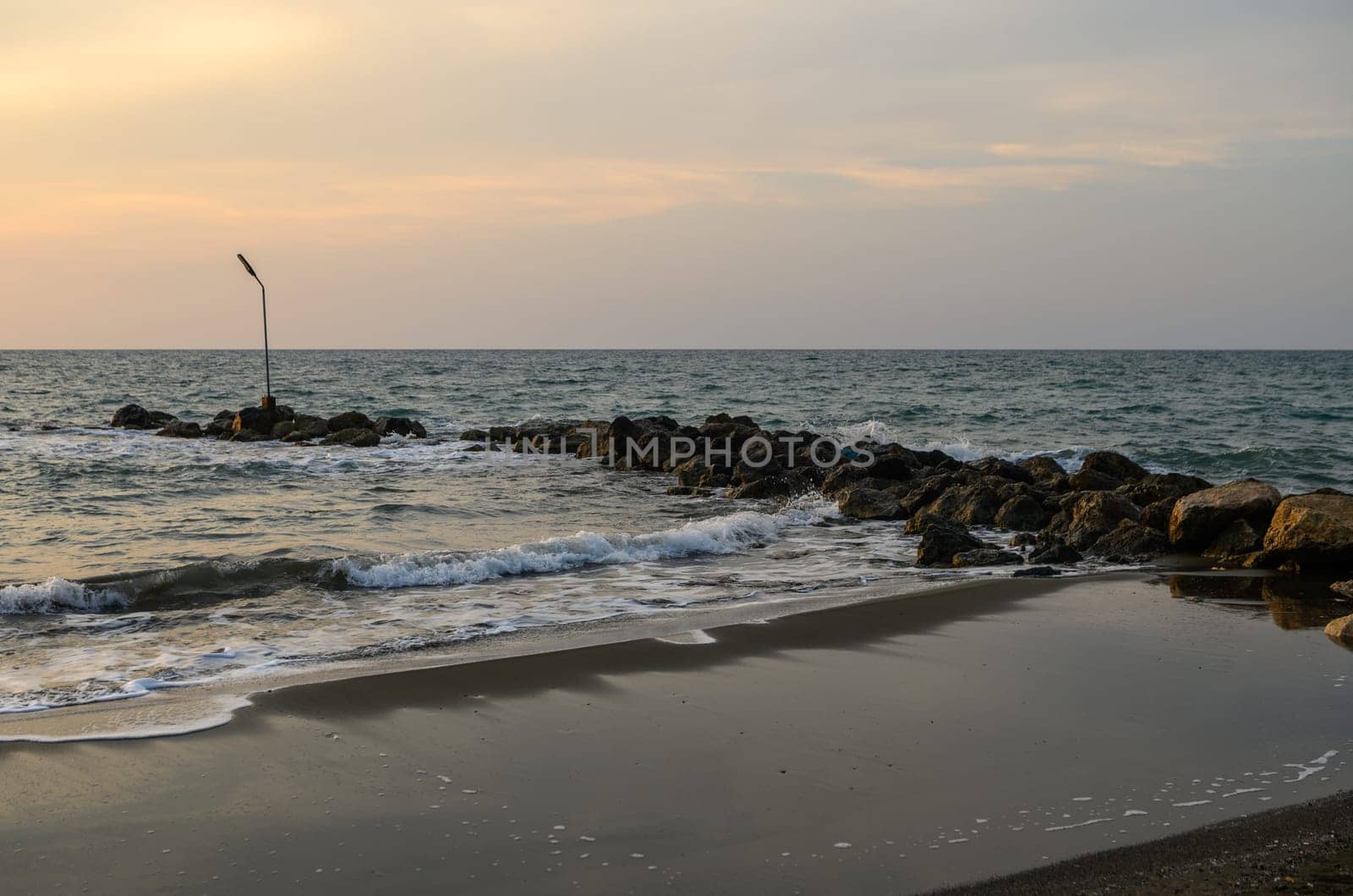 shore of the Mediterranean sea autumn 2023 in the setting sun