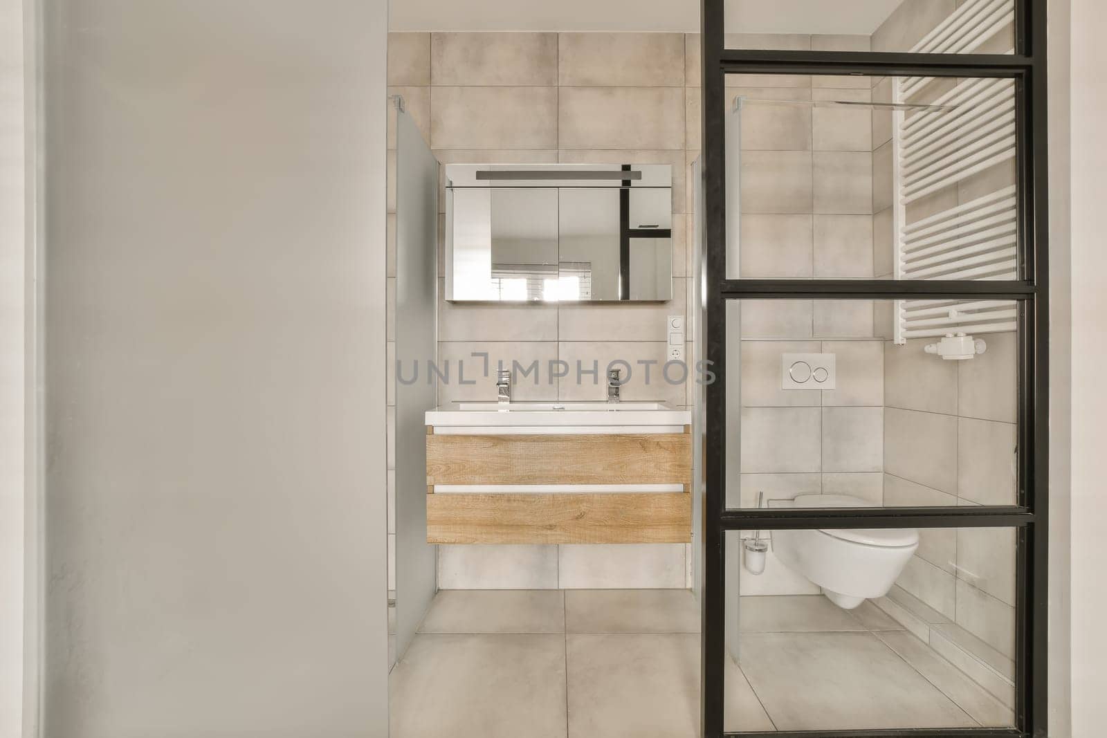 a bathroom with a toilet and a sink and a by casamedia