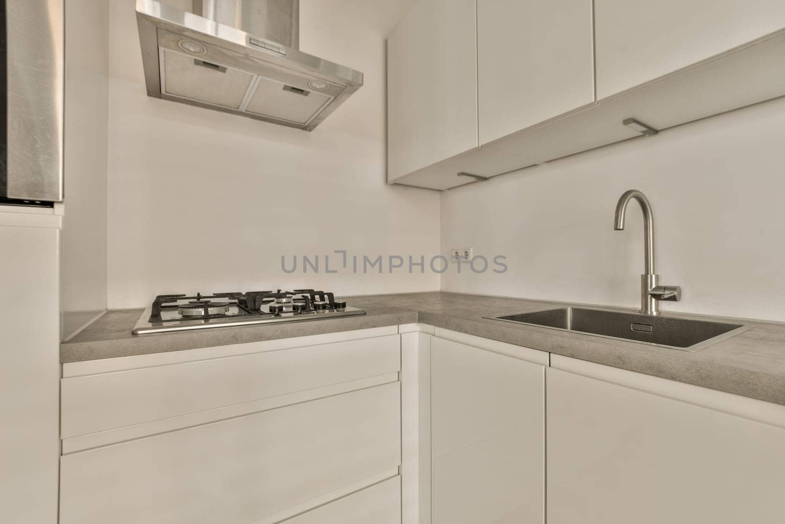 a kitchen with white cabinets and a sink by casamedia