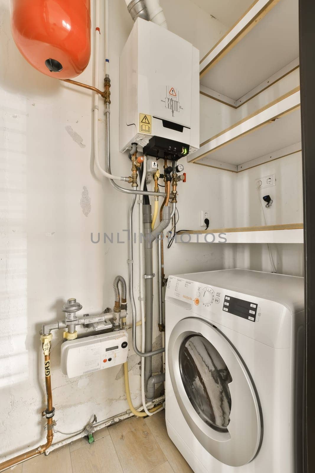 a washing machine and a boiler in a white room by casamedia