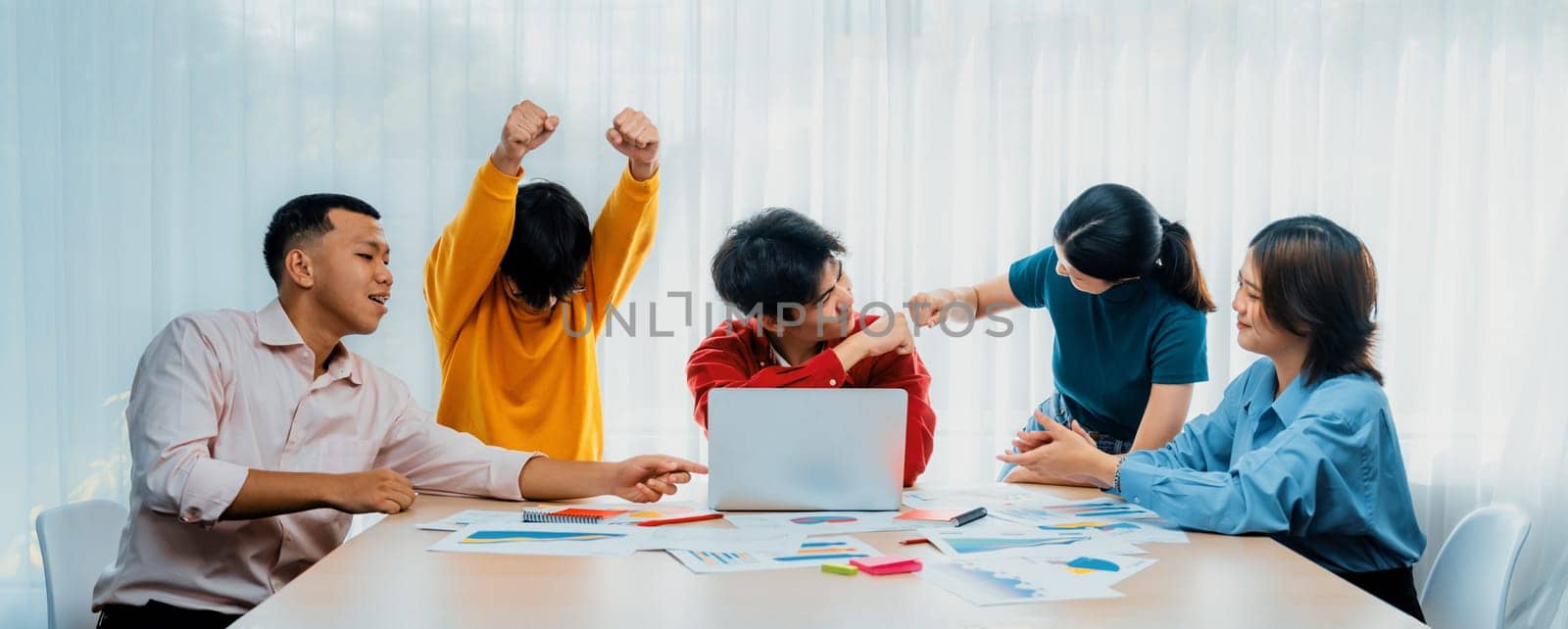 Excited and happy startup company employee celebrate after make successful strategic business marketing planning. Teamwork and positive attitude create productive and supportive workplace. Synergic