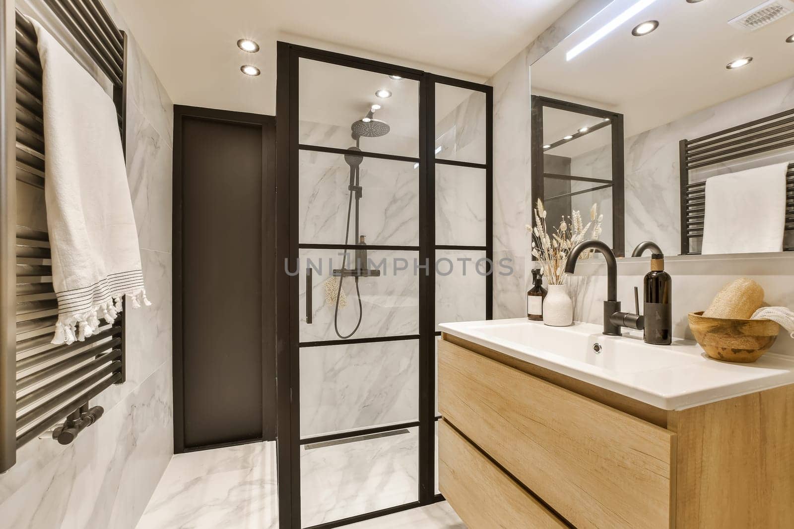 a bathroom with a shower and a sink by casamedia
