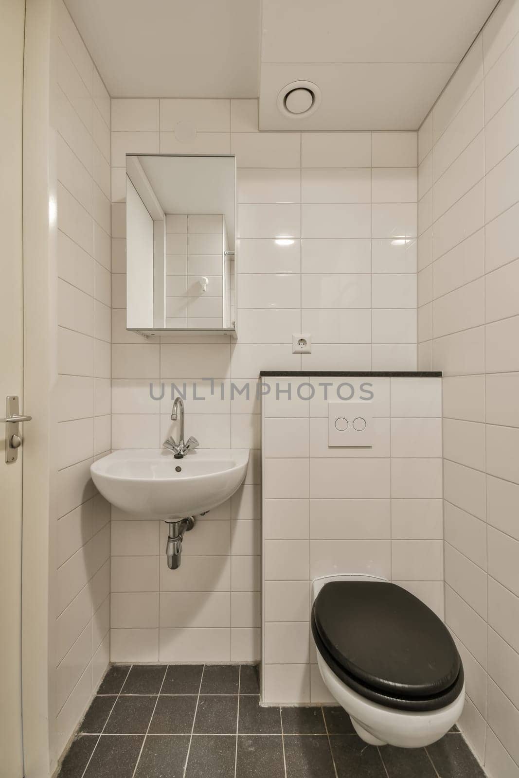 a small bathroom with a toilet and a sink by casamedia