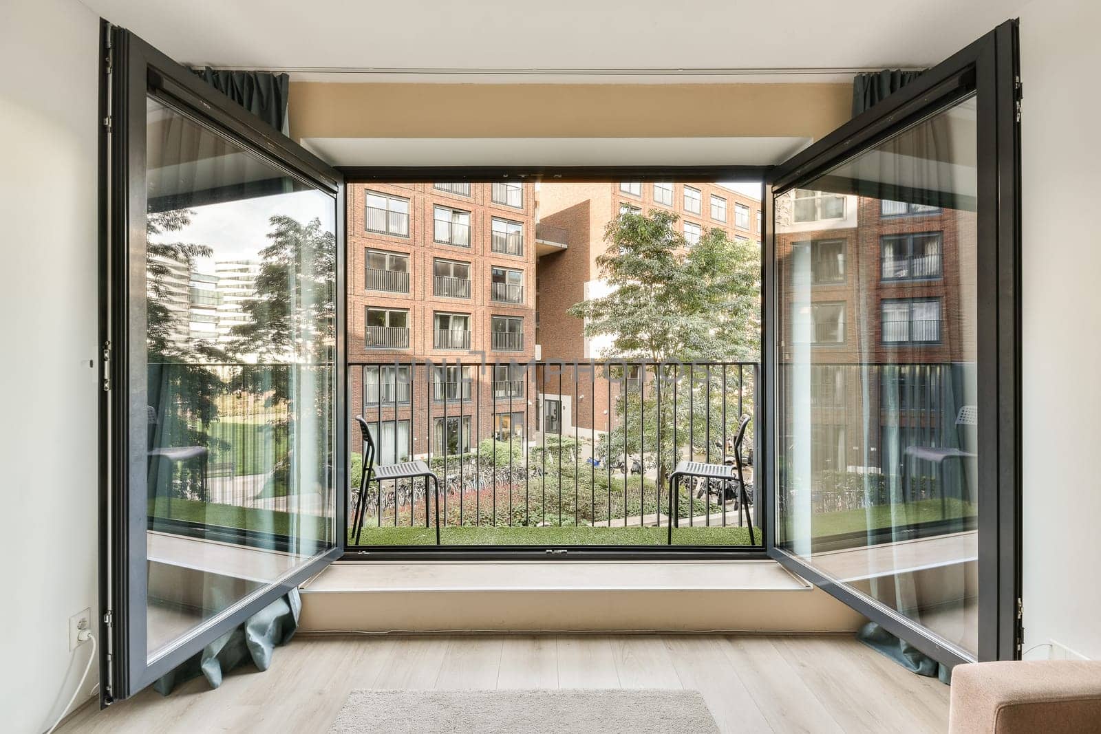 a living room with sliding glass doors that open to an outside patio and lawn area in front of the house