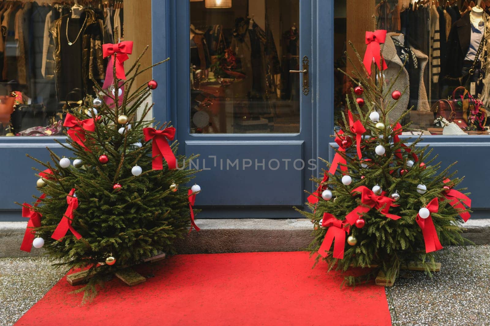 The store facade is decorated with Christmas trees.