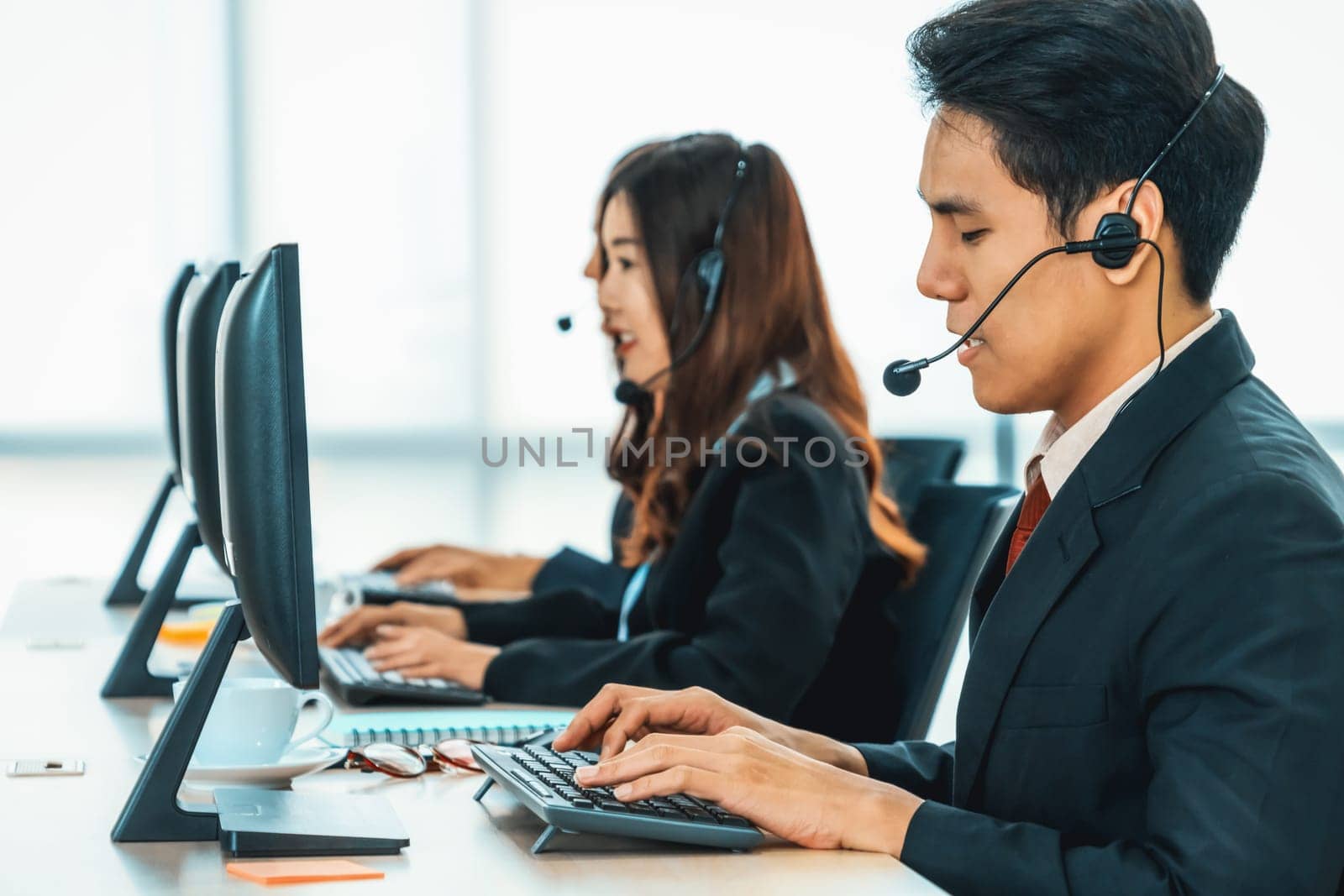 Business people wearing headset working in office Jivy by biancoblue