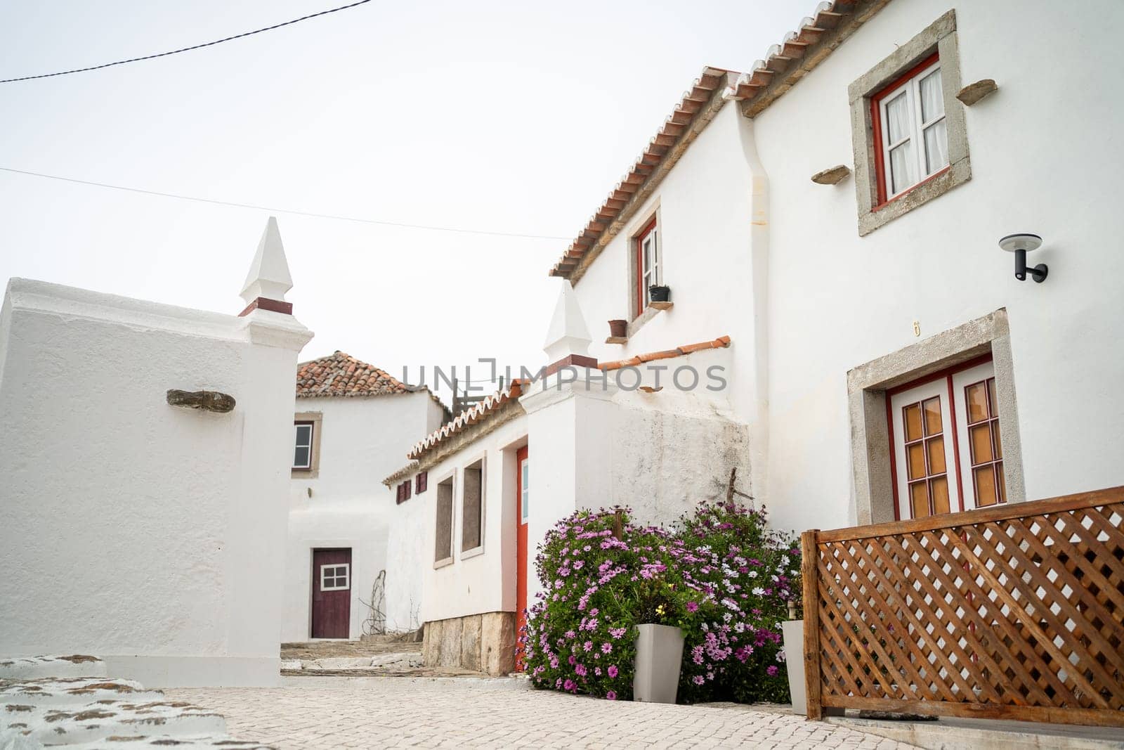 Small streets in Portugal surrounded by white two-storey houses by andreonegin