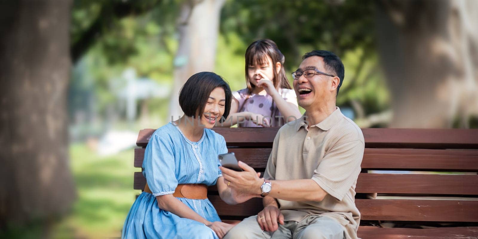 Grandparent playing togetherness with a granddaughter in the park in the morning. Family, love and grandchild bonding with grandfather and grandma in a park. concept child and senior.