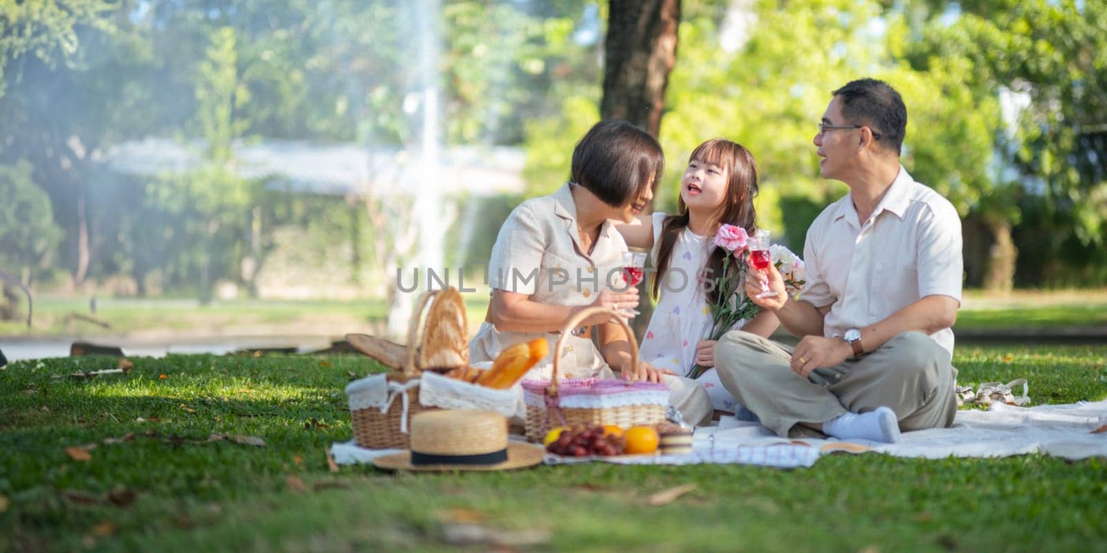 Grandparent playing togetherness with a granddaughter in the park in the morning. Family, love and grandchild bonding with grandfather and grandma in a park. concept child and senior by nateemee