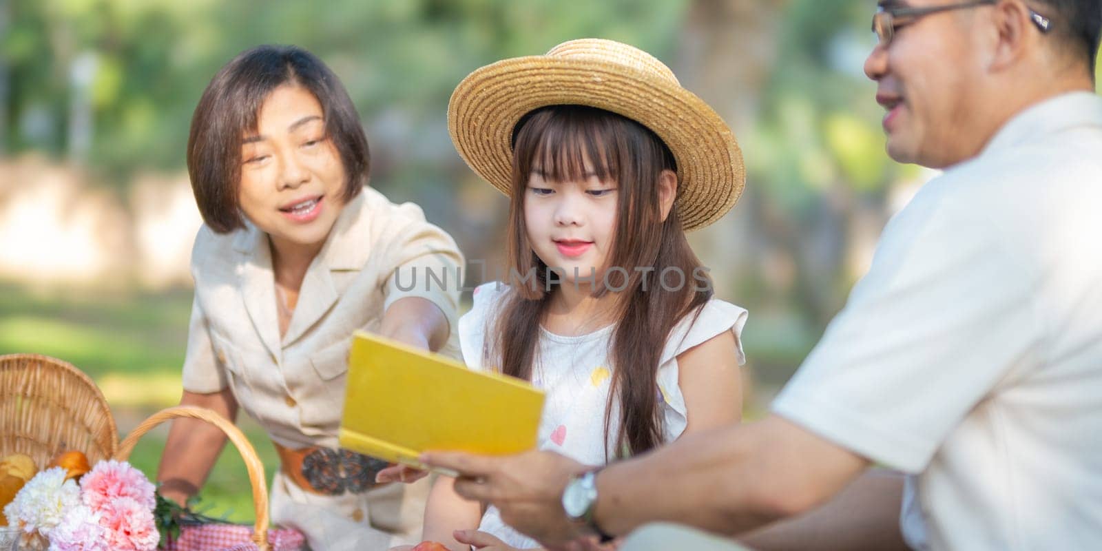 Grandparent playing togetherness with a granddaughter in the park in the morning. Family, love and grandchild bonding with grandfather and grandma in a park. concept child and senior by nateemee