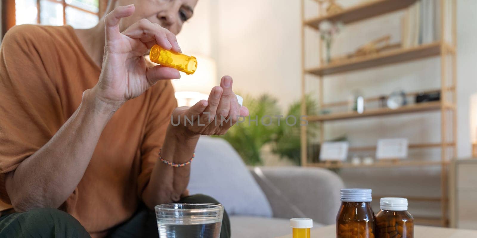 Medicine and healthcare of senior woman taking daily pill for ill, medication and sick elderly with medical drugs, vitamin or supplement in his hand.
