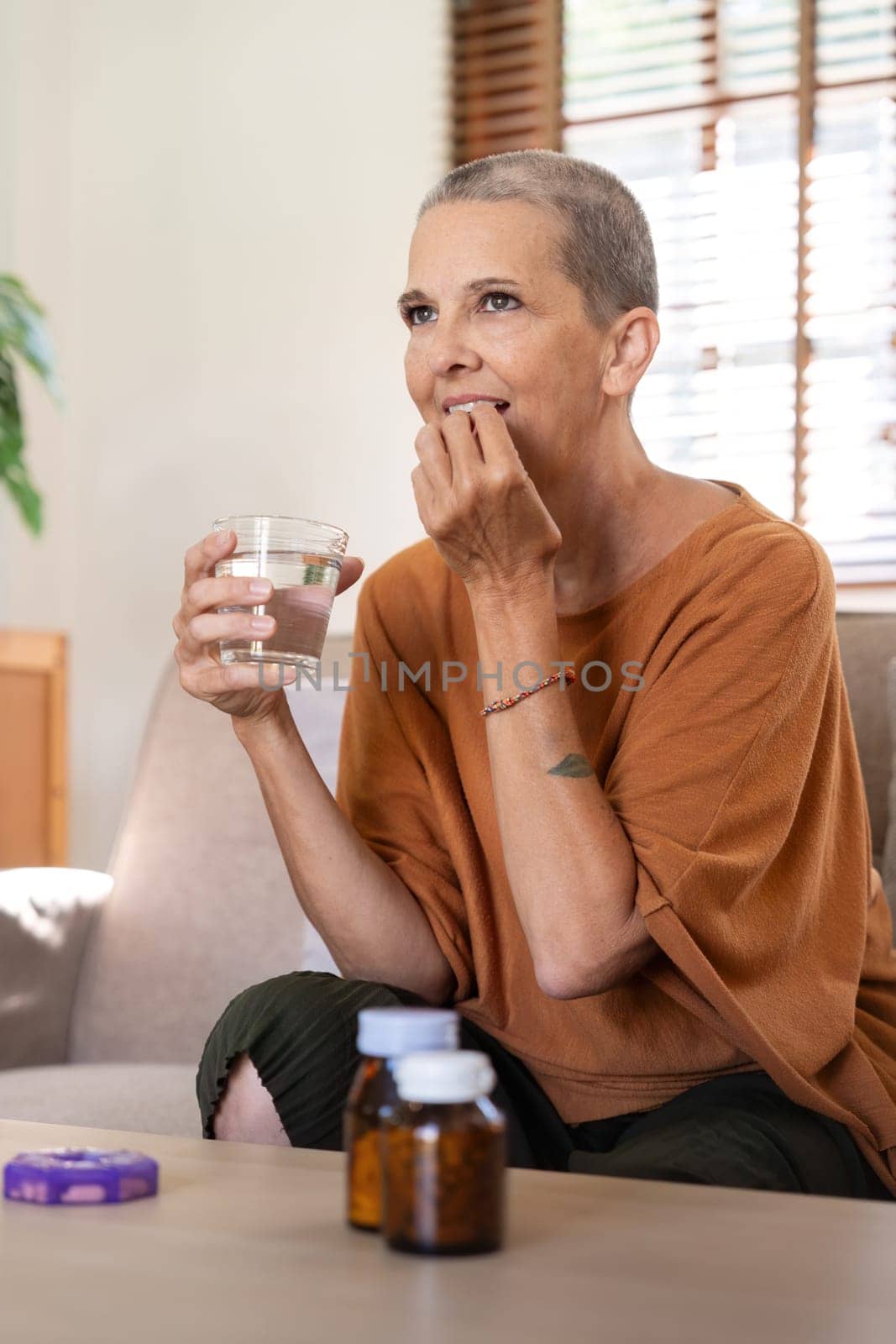 Medicine and healthcare of senior woman taking daily pill for relief illness. vitamin or supplement in his hand.