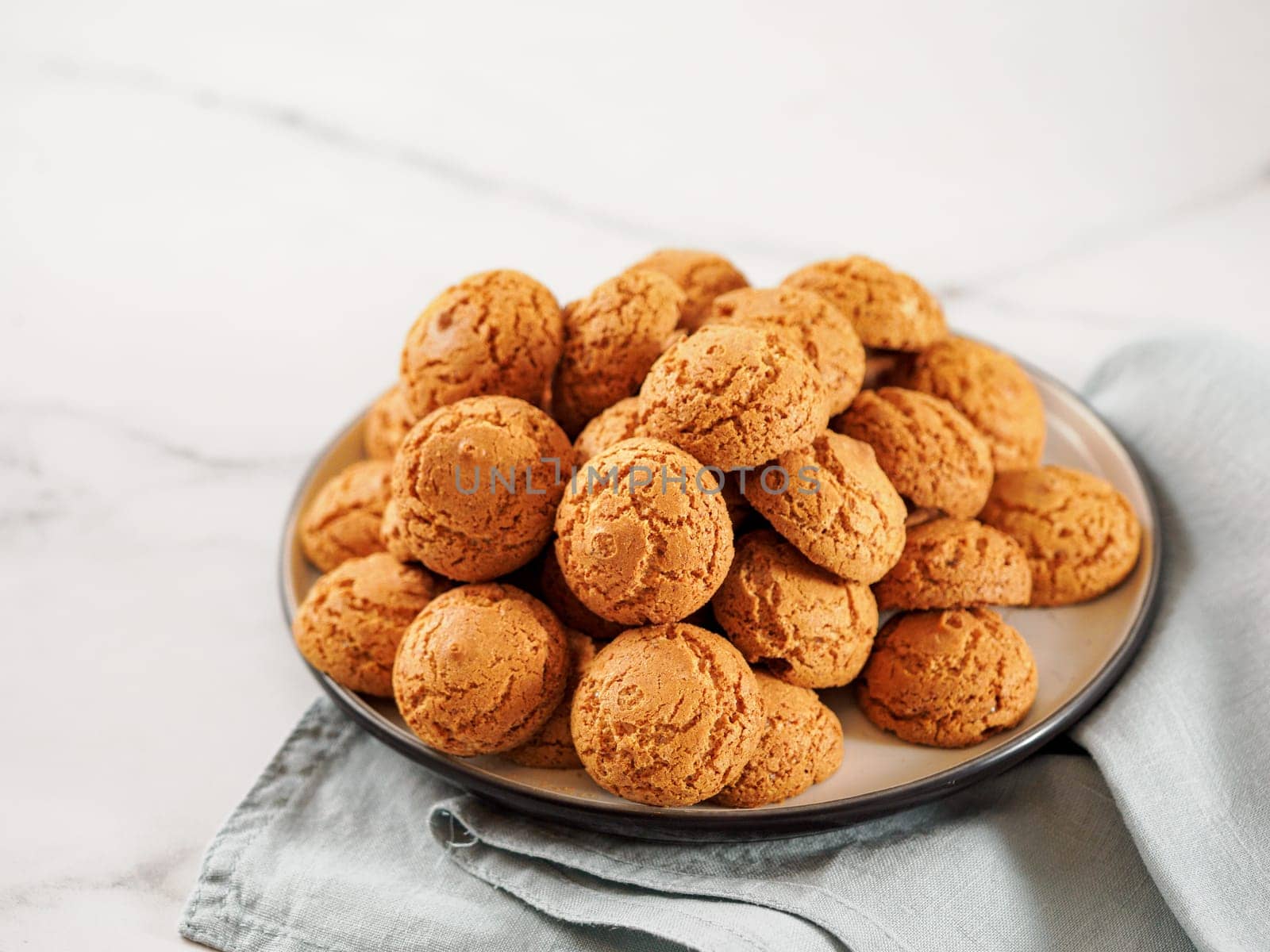 Plate of cookie amaretti on white marble by fascinadora