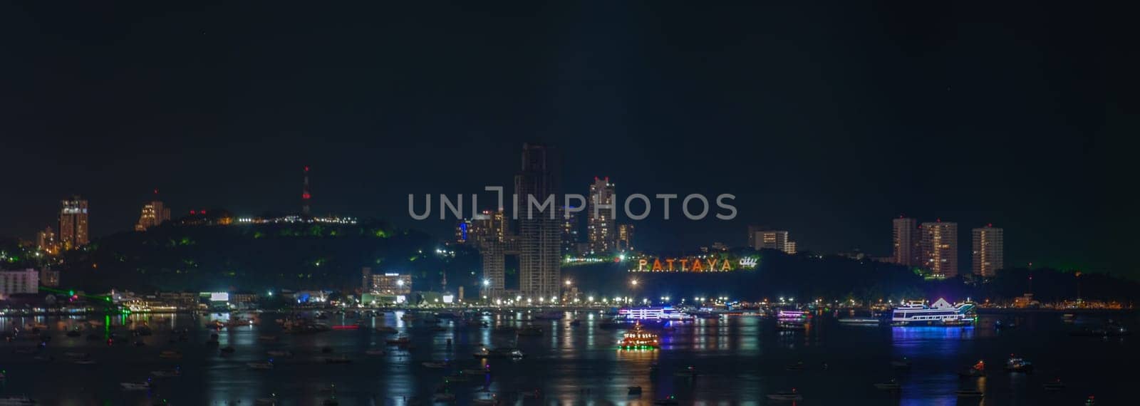 Pattaya Thailand, a view of the city skyline at night with hotels and skyscrapers buildings by fokkebok
