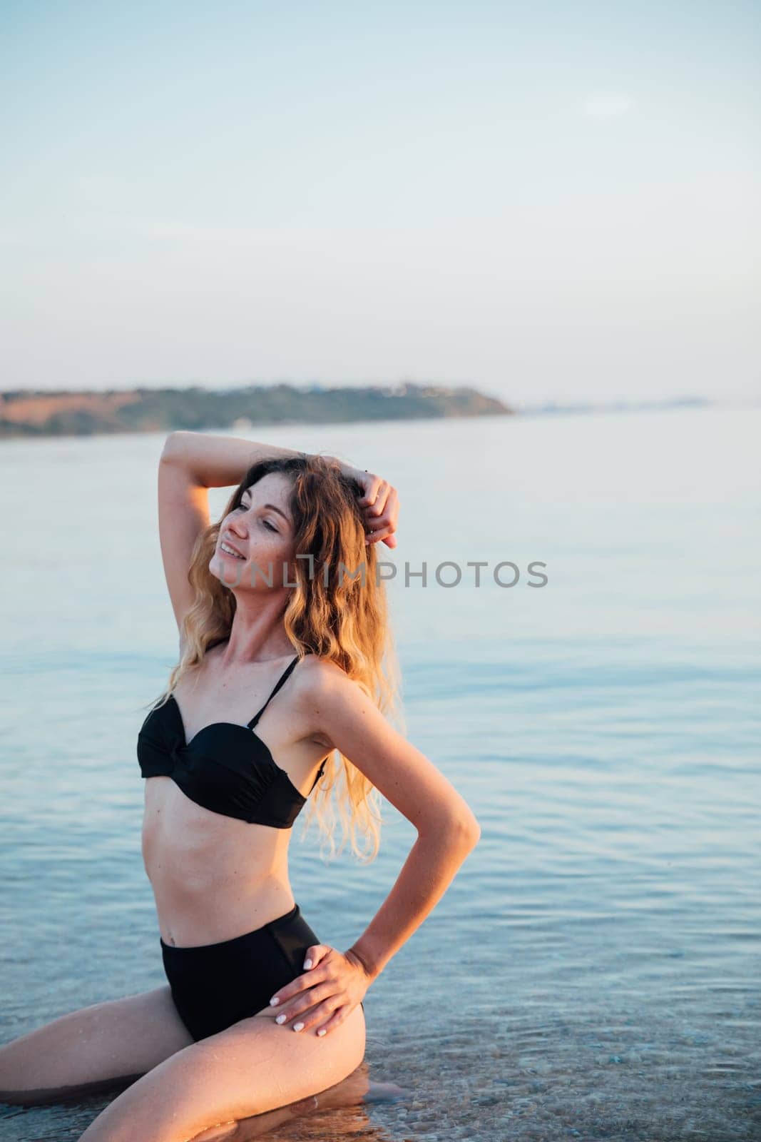 woman in black swimsuit on the beach rest walking trip by Simakov