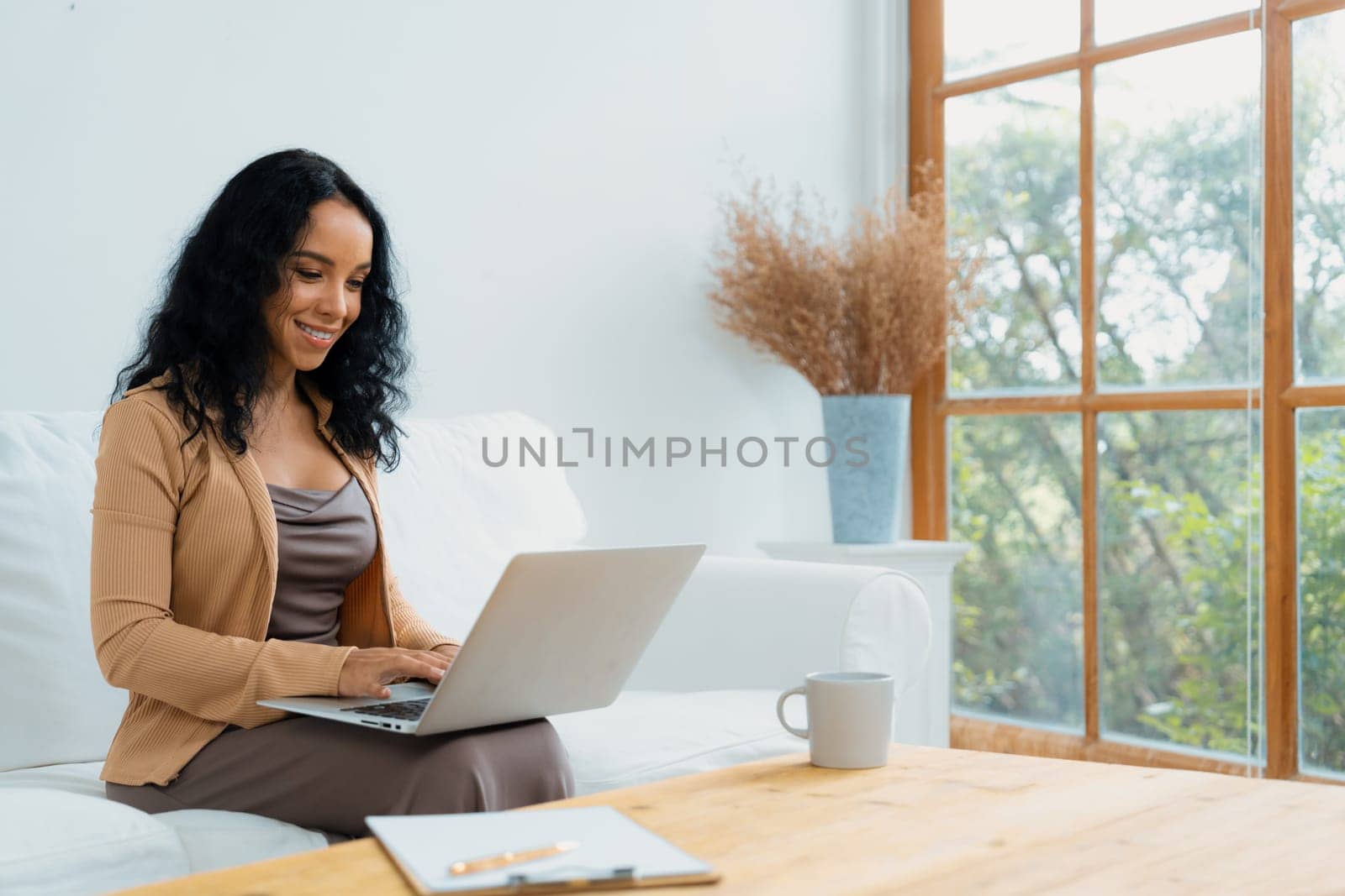 African-American woman using laptop computer for crucial work by biancoblue