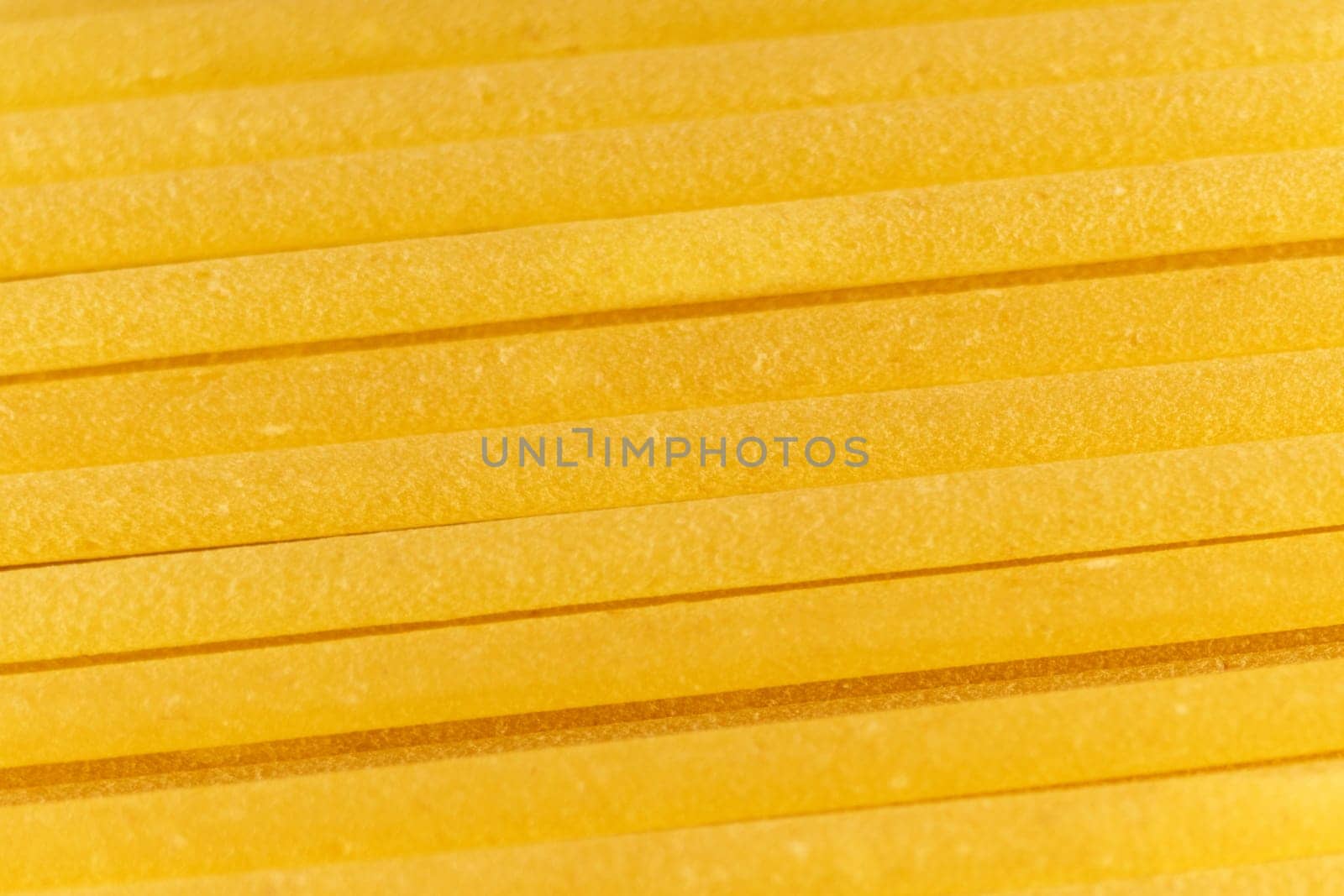 Italian Spaghetti pasta raw food background or texture close up. Selective focus