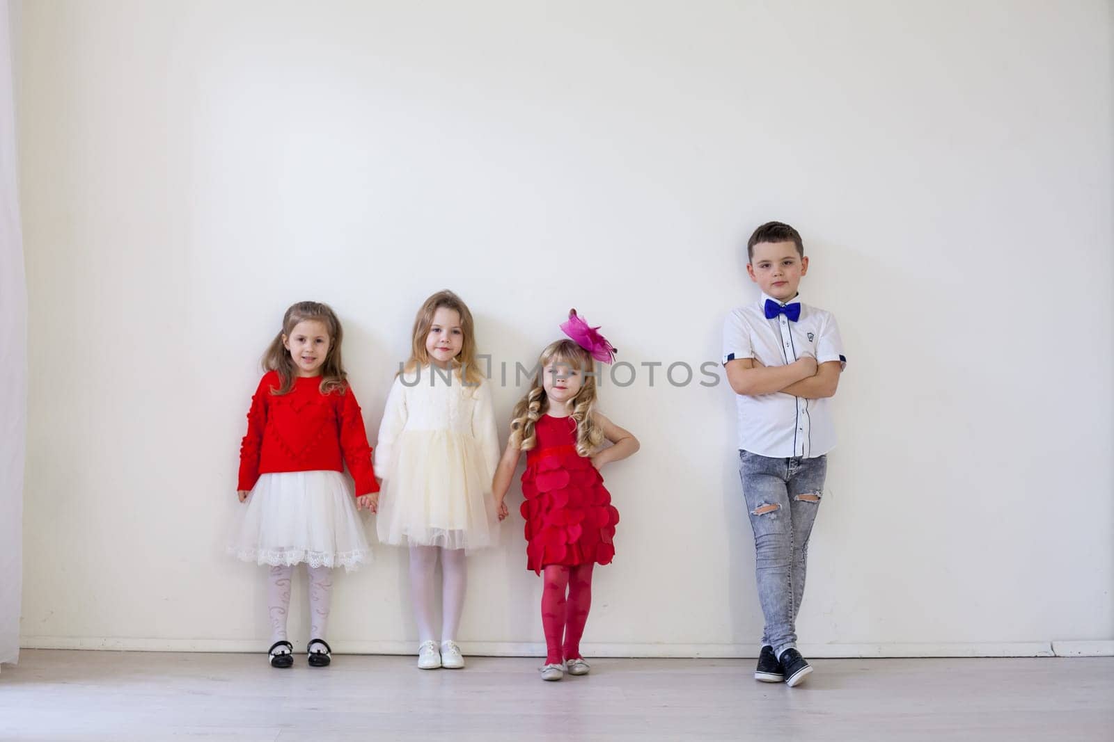 a four children standing in a bright holiday room