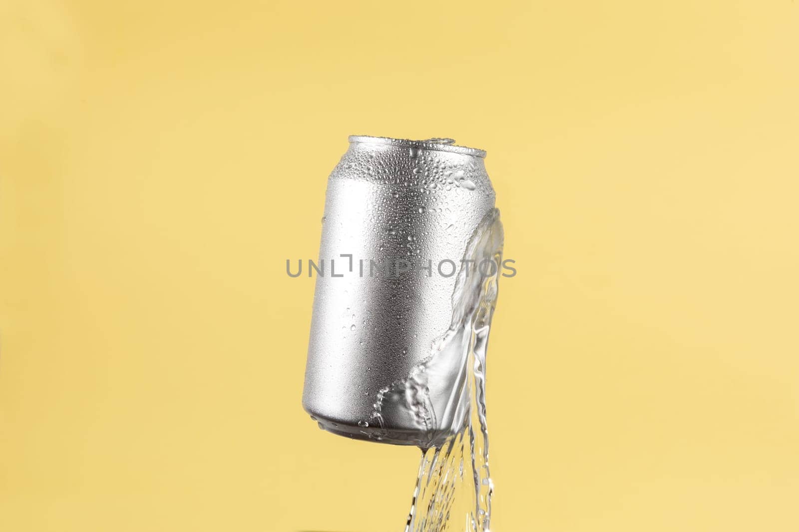Aluminium beer or soda drinking can with water splash on light yellow background by TropicalNinjaStudio