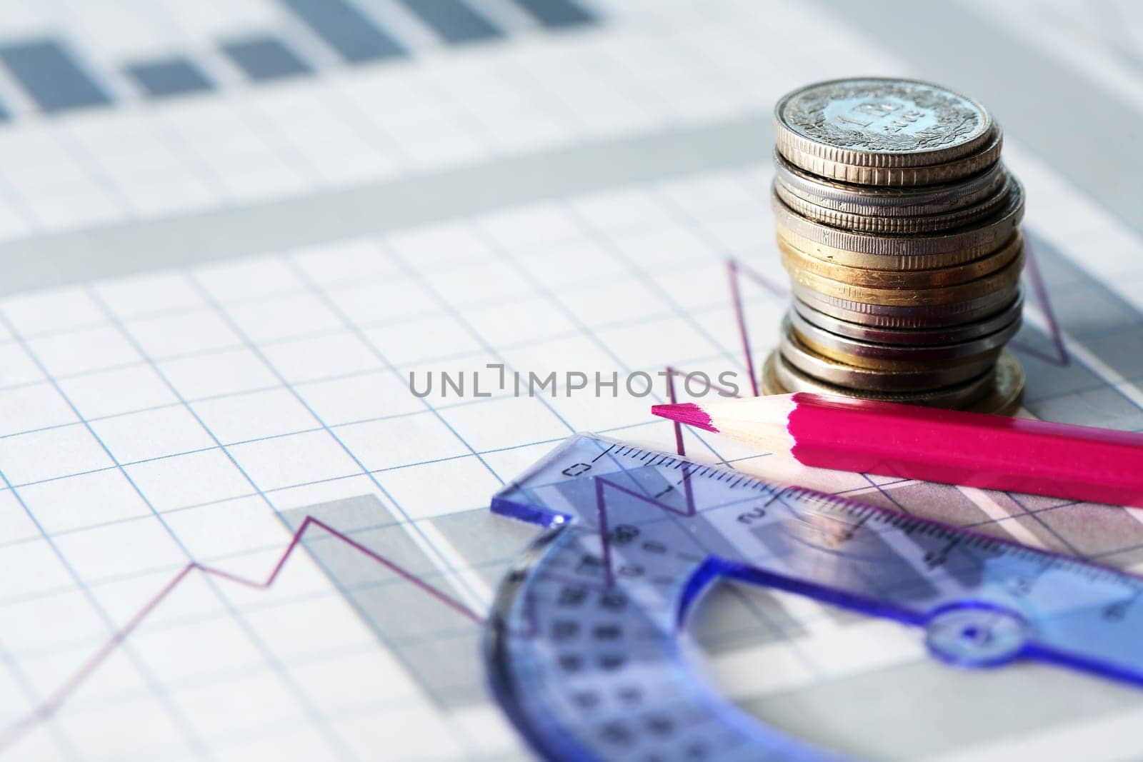 Business concept. Pencil and ruler on the background of the diagram near coins