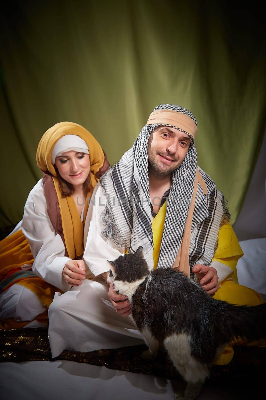 A couple in love or a married couple in stylized Eastern clothing from Israel, Palestine, Iran, Pakistan together. Tender photo session in the style of the Middle East and the Bible