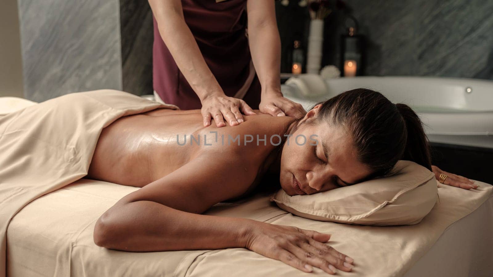 Asian woman getting a Thai massage in a Massage room in Thailand at a luxury hotel by fokkebok