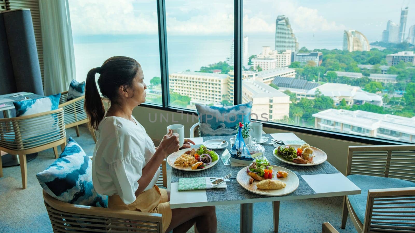 Asian Thai woman eating breakfast in a luxury hotel in Thailand by fokkebok