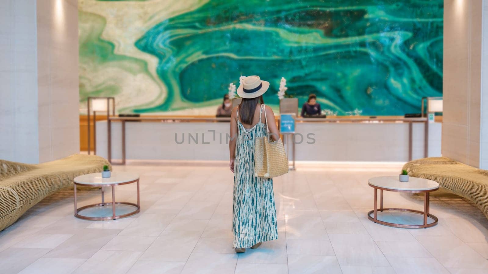 a Asian woman in a hotel lobby of a luxury hotel in Thailand