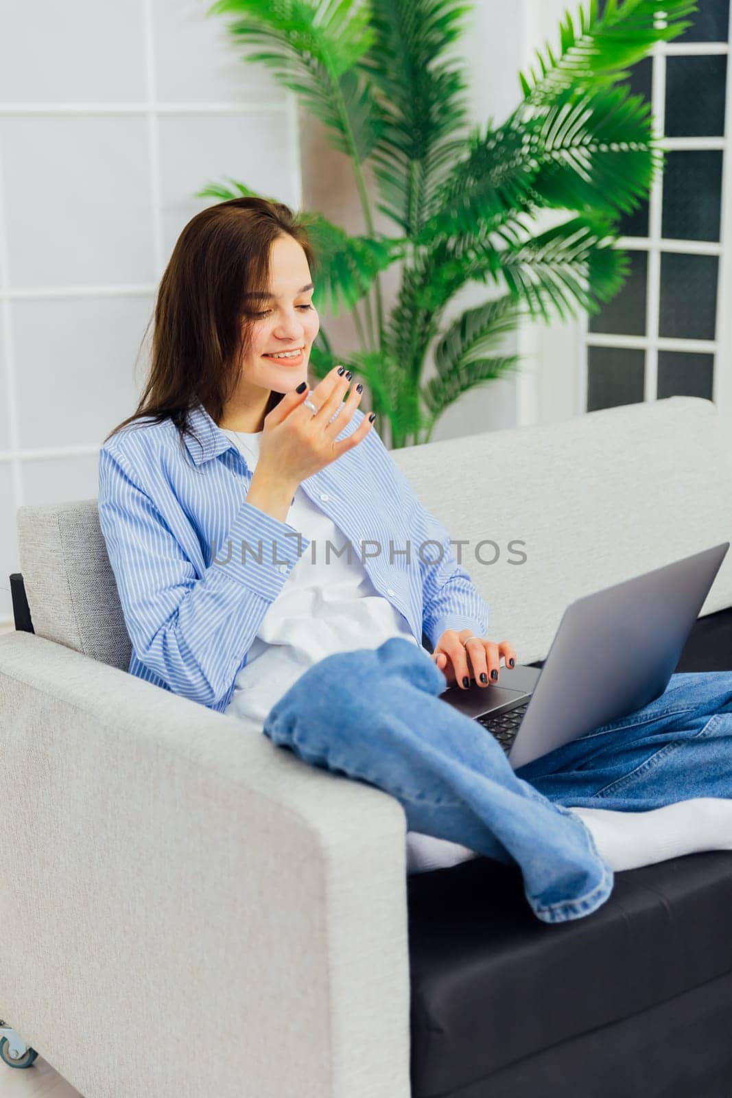 woman in a room with computer technology online communication learning internet by Simakov