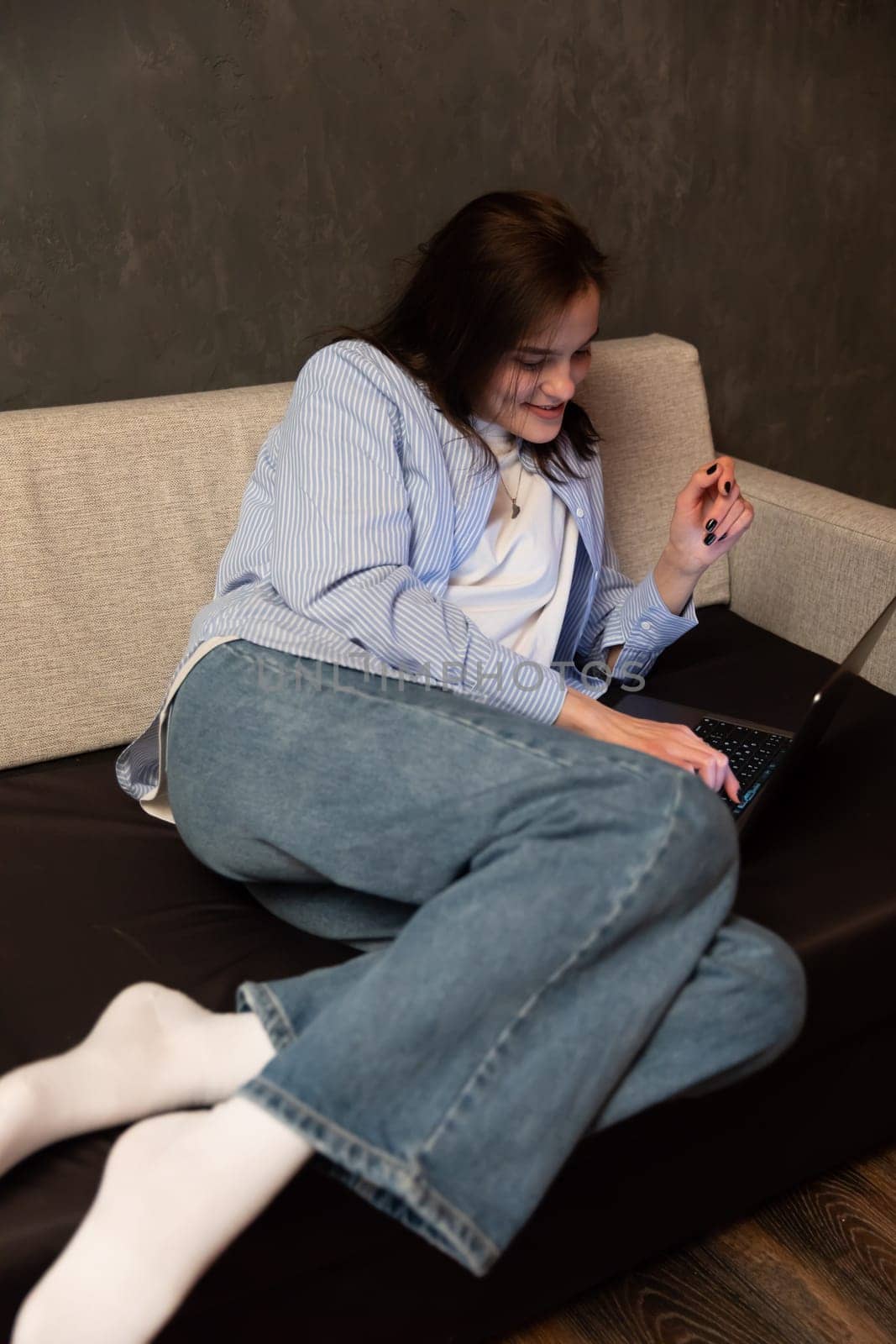 woman with laptop in room on remote work internet communication IT online by Simakov