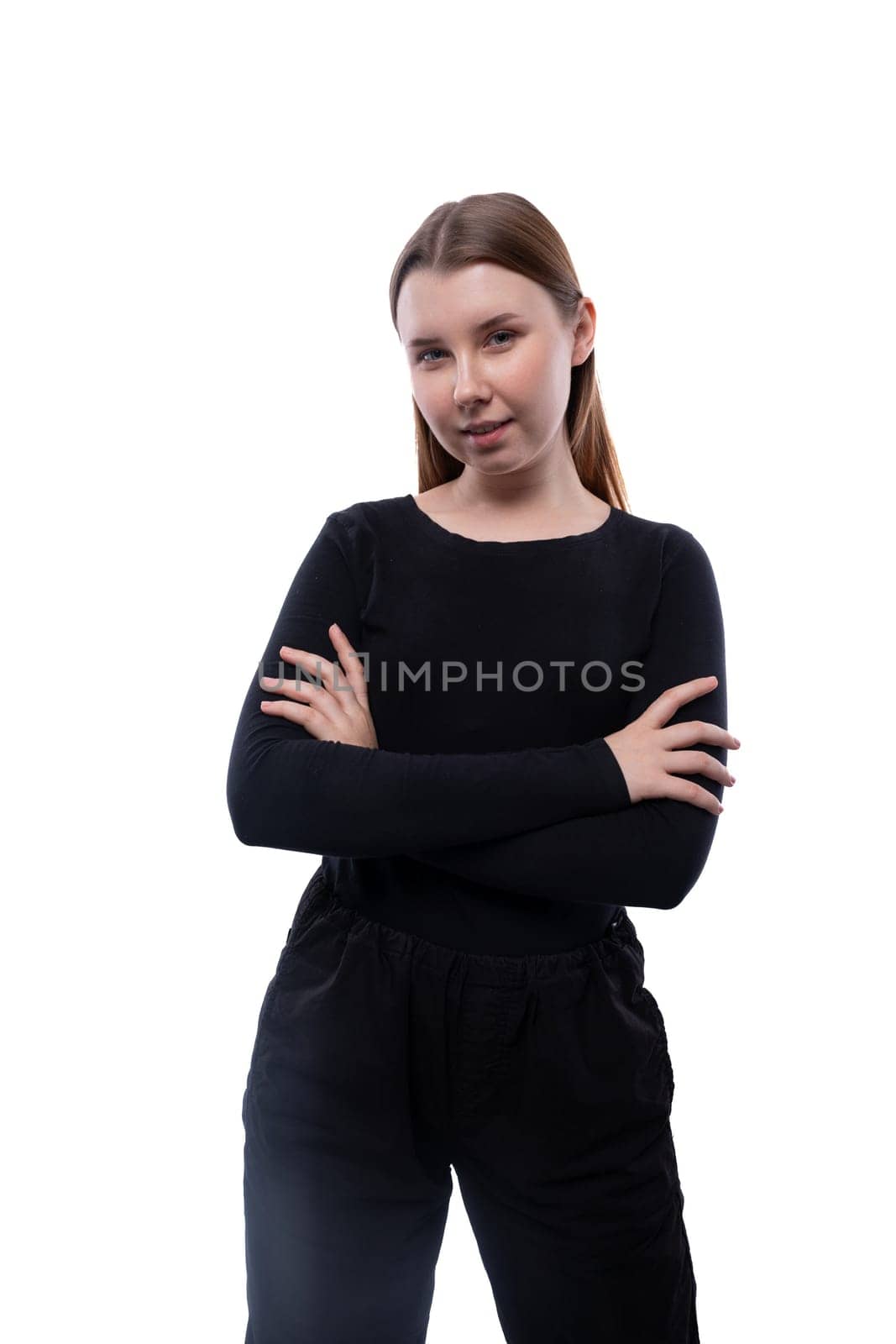 Portrait of a confident European schoolgirl on a white background with copyspace.