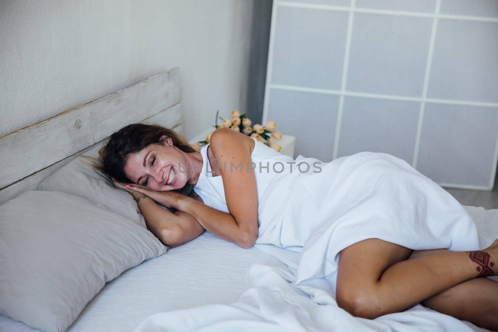 at the woman in the bedroom woke up in the morning with a smile
