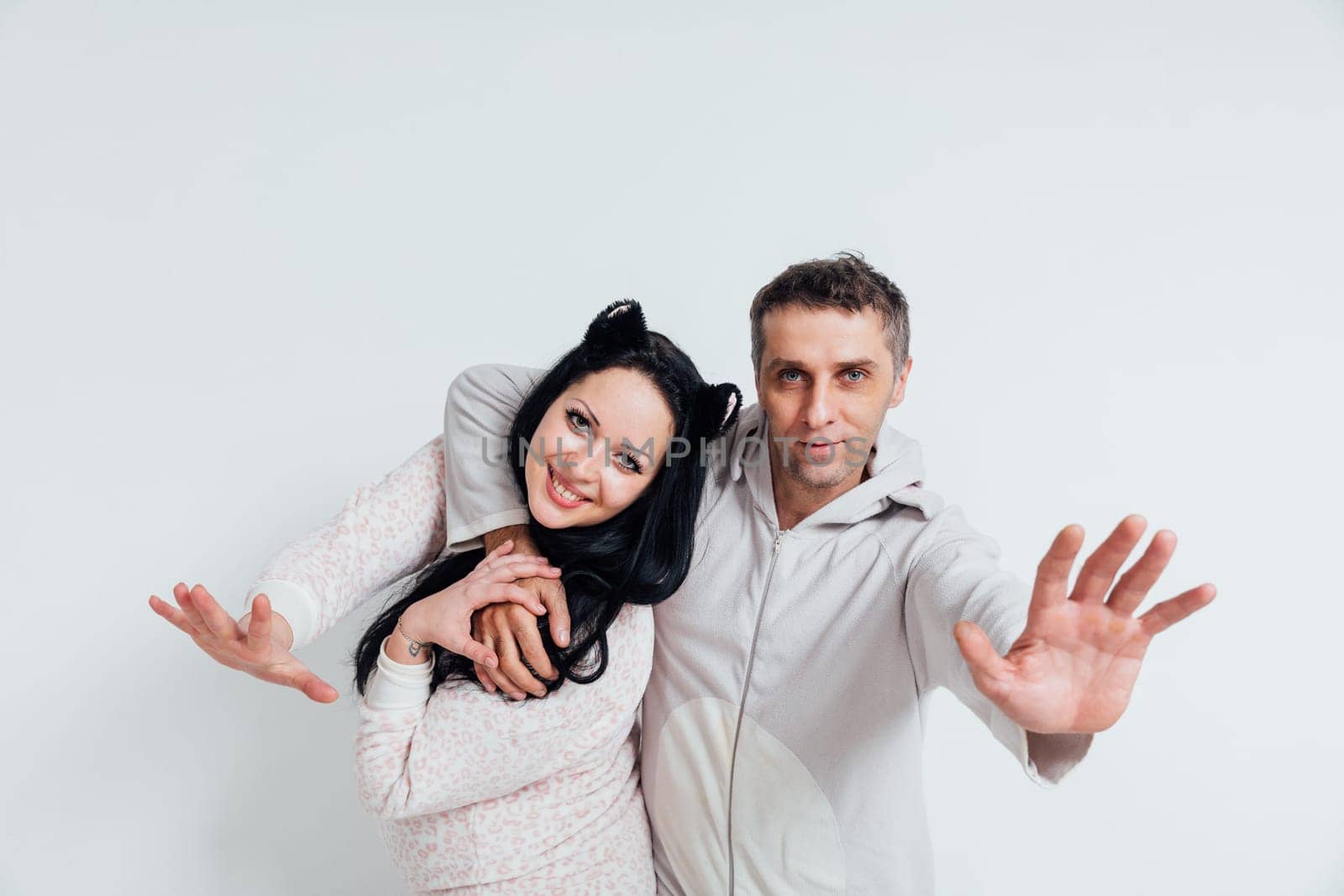 man reaches out his hand forward hugs a woman husband and wife