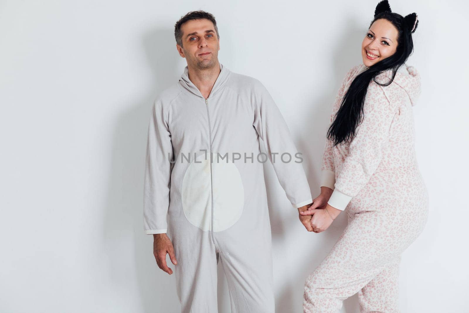 a husband and wife man and woman in love in pajamas in the morning in a bright room