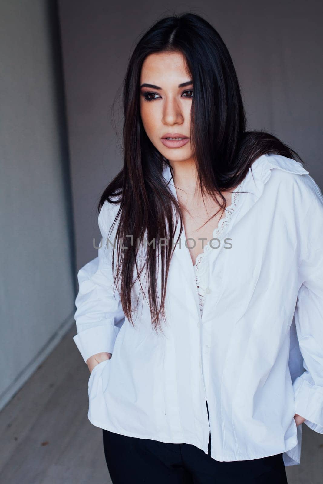 disheveled brunette woman in white portrait shirt by Simakov