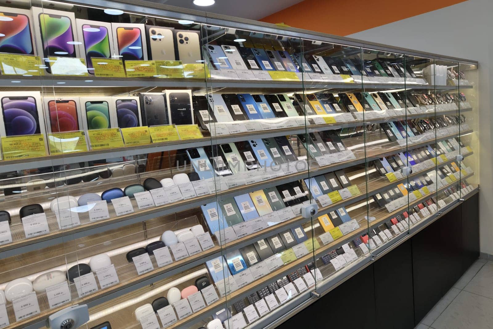 Moscow, Russia - Nov 11. 2023. Cell phones and wireless headphones in DNS network store selling household appliances in Zelenograd by olgavolodina